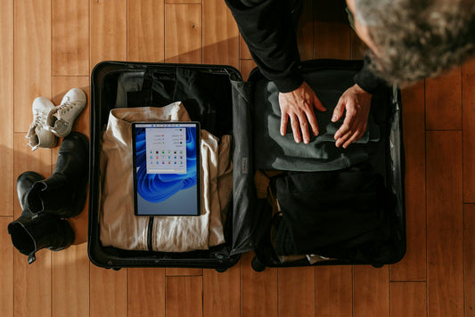 Overhead view of a person packing a suitcase